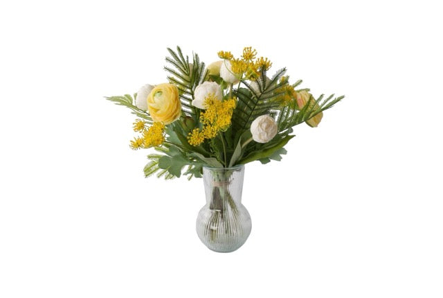 productfoto van een Fris Voorjaars Kunstbloemen Boeket in Geel met Wit met Tulpen wit, Fluitekruid geel, Ranonkel Geel, Tak Mimosa op een glas vaas van helder glas 