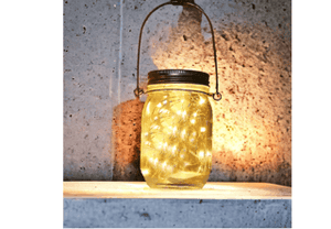 glazen solarlamp brandend voor een betonmuur