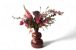 kunstboeket van kunstbloemen in blauw lila en roze  op een rode metalen vaas - Winq