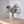 PlukBoeket Kunstbloemen Lila en Blauw op een tafel in een hoek tegen een lichte muur,.