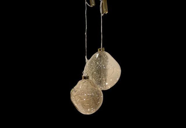 Organic Glass Ball in 2 maten diameter 12 en 15cm in de kleur champagne met led-verlichting op batterij op een zwarte achtergrond